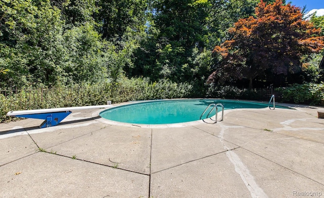 6674 Balmoral Ter, Clarkston, MI 48346 - outdoor pool with a diving board and a patio