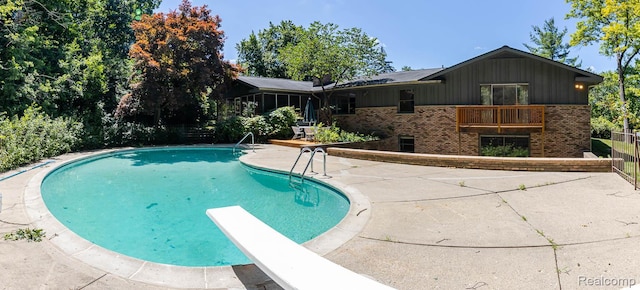 6674 Balmoral Ter, Clarkston, MI 48346 - swimming pool featuring a patio area and a diving board