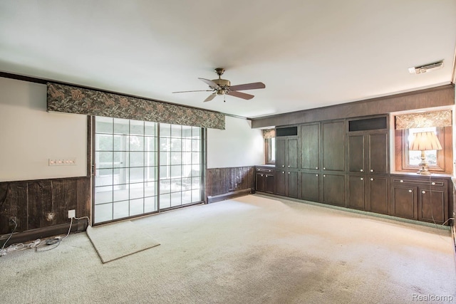 6674 Balmoral Ter, Clarkston, MI 48346 - unfurnished bedroom with carpet floors, wooden walls, wainscoting, ceiling fan, and crown molding