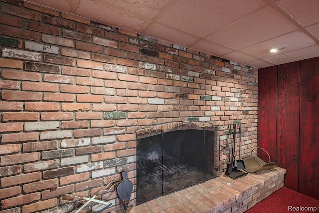 6674 Balmoral Ter, Clarkston, MI 48346 - detailed view of a drop ceiling, a brick fireplace, and wooden walls