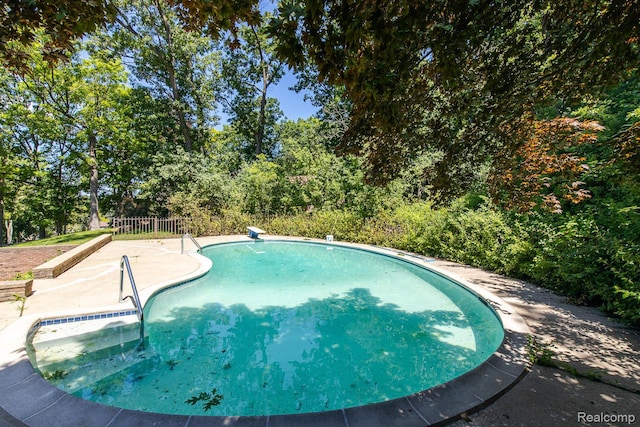 6674 Balmoral Ter, Clarkston, MI 48346 - swimming pool featuring a patio and view of wooded area