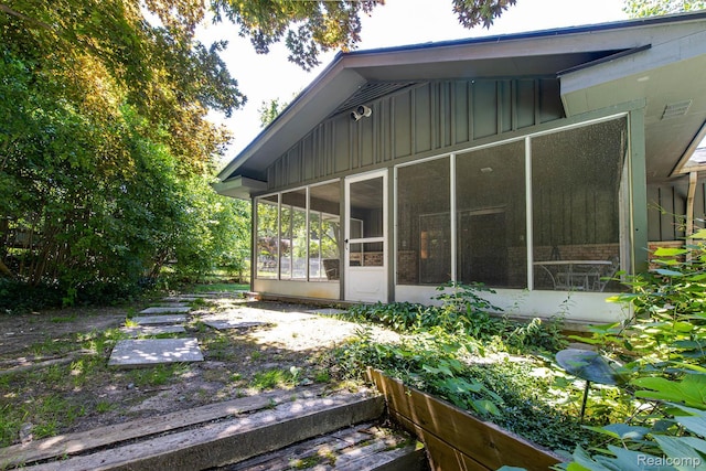 6674 Balmoral Ter, Clarkston, MI 48346 - back of house featuring a sunroom and board and batten siding