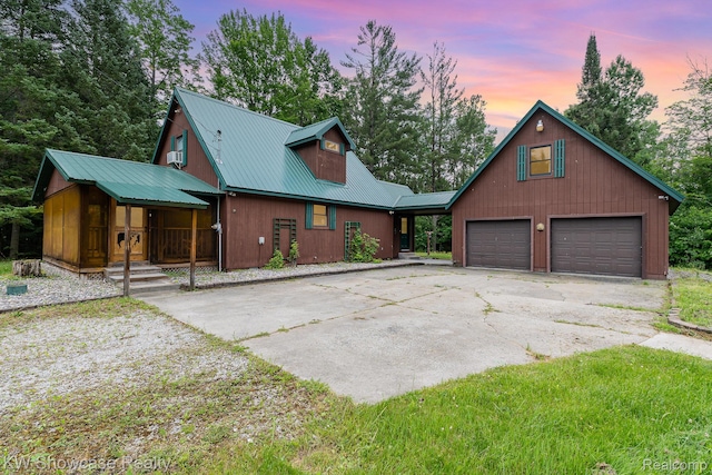 699 W Cherry Creek Rd, Mio, MI 48647 - chalet / cabin featuring a metal roof, driveway, a garage, and covered porch