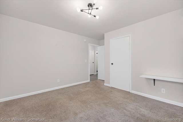 22281 Poinciana St, Southfield, MI 48033 - empty room featuring a chandelier and carpet floors