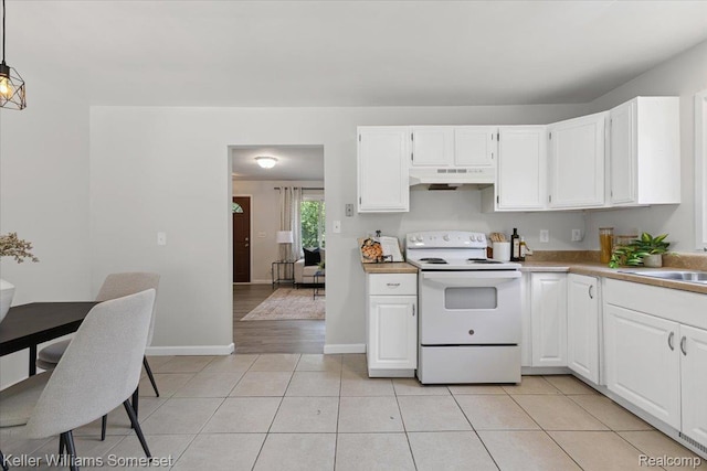 22281 Poinciana St, Southfield, MI 48033 - kitchen featuring white range with electric cooktop, under cabinet range hood, white cabinets, light tile patterned floors, and light countertops