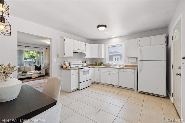 22281 Poinciana St, Southfield, MI 48033 - kitchen with white appliances, under cabinet range hood, white cabinets, and light tile patterned floors