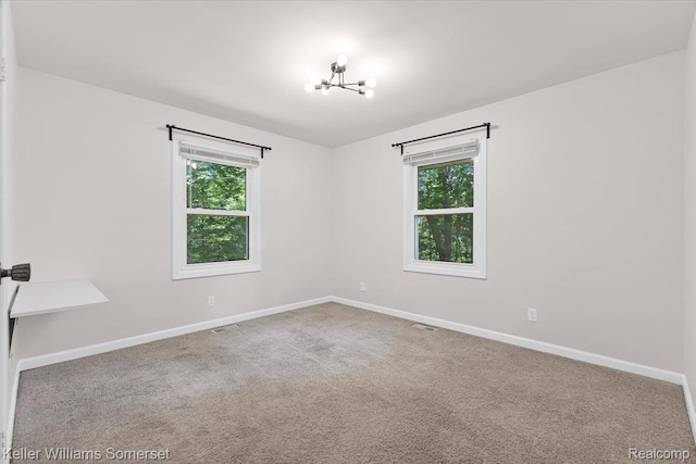 22281 Poinciana St, Southfield, MI 48033 - carpeted spare room featuring healthy amount of natural light and a chandelier