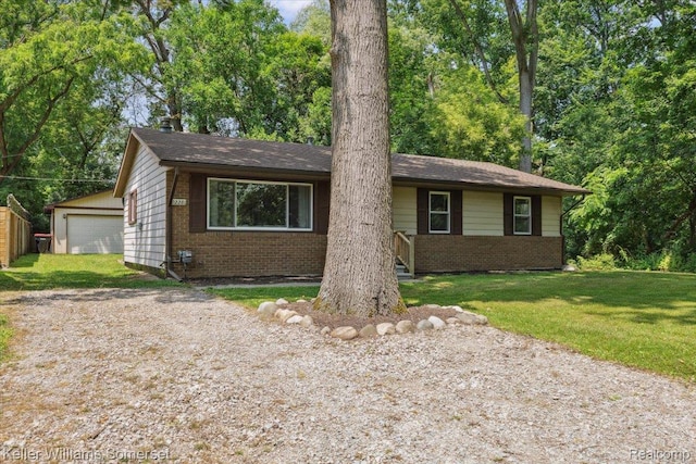 22281 Poinciana St, Southfield, MI 48033 - ranch-style home featuring brick siding, a front lawn, and a garage