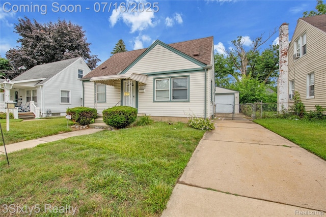 2133 Bailey St, Dearborn, MI 48124 - bungalow featuring a shingled roof, an outbuilding, and a garage