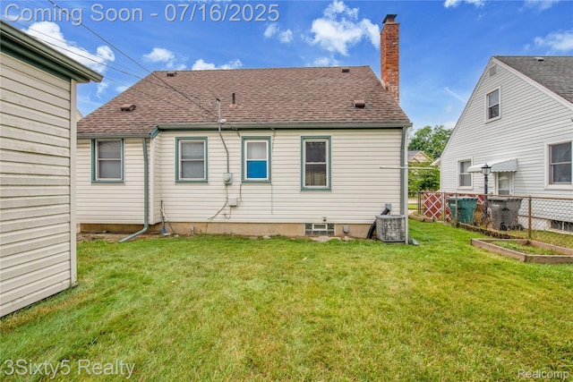 2133 Bailey St, Dearborn, MI 48124 - back of house with roof with shingles, a chimney, and a vegetable garden