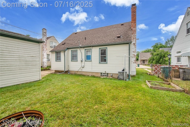 2133 Bailey St, Dearborn, MI 48124 - rear view of house with a vegetable garden, a shingled roof, and a chimney
