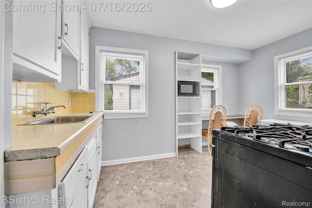 2133 Bailey St, Dearborn, MI 48124 - kitchen with black appliances, white cabinets, tasteful backsplash, light countertops, and open shelves