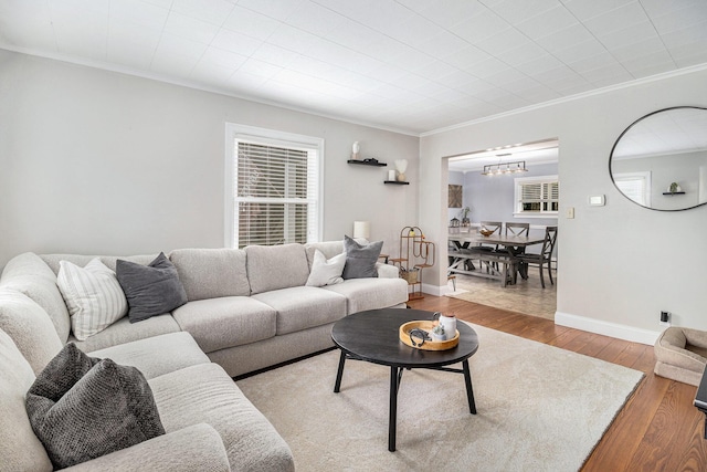 407 W Pine St, Big Rapids, MI 49307 - living area with a chandelier, ornamental molding, and wood finished floors