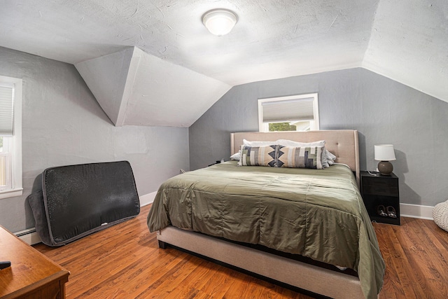 407 W Pine St, Big Rapids, MI 49307 - bedroom featuring vaulted ceiling, wood finished floors, multiple windows, and a textured ceiling