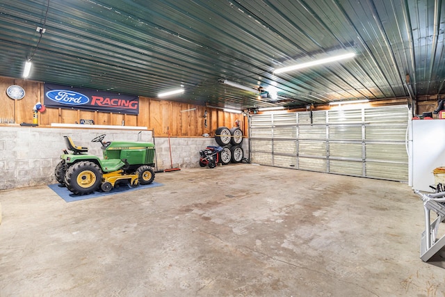 407 W Pine St, Big Rapids, MI 49307 - garage with freestanding refrigerator and concrete block wall