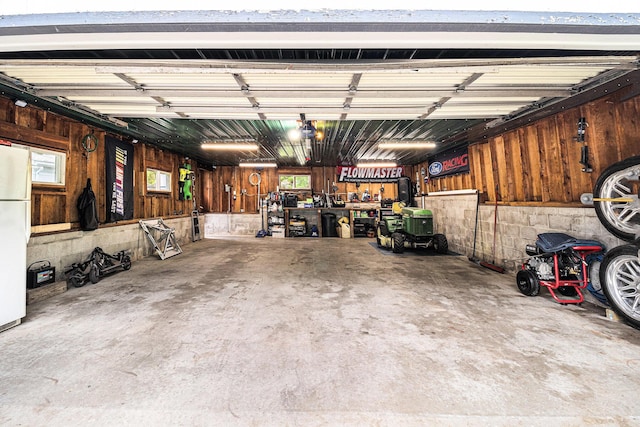 407 W Pine St, Big Rapids, MI 49307 - garage with freestanding refrigerator and wooden walls