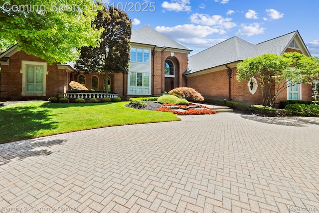 18878 Oak Leaf Ln, Northville, MI 48168 - view of front facade with brick siding and a front lawn