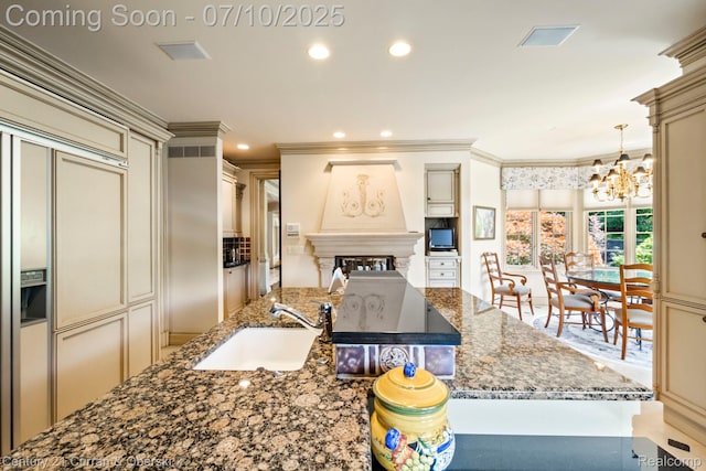 18878 Oak Leaf Ln, Northville, MI 48168 - kitchen featuring cream cabinetry, a chandelier, dark stone counters, ornamental molding, and recessed lighting