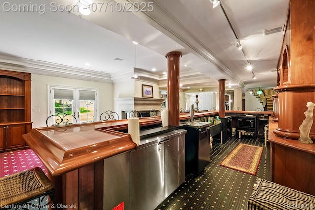 18878 Oak Leaf Ln, Northville, MI 48168 - kitchen featuring decorative columns, track lighting, a fireplace, dark carpet, and ornamental molding