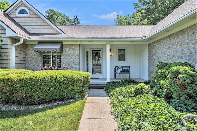 2032 Crestline, Burton, MI 48509 - view of exterior entry featuring a porch, brick siding, and roof with shingles