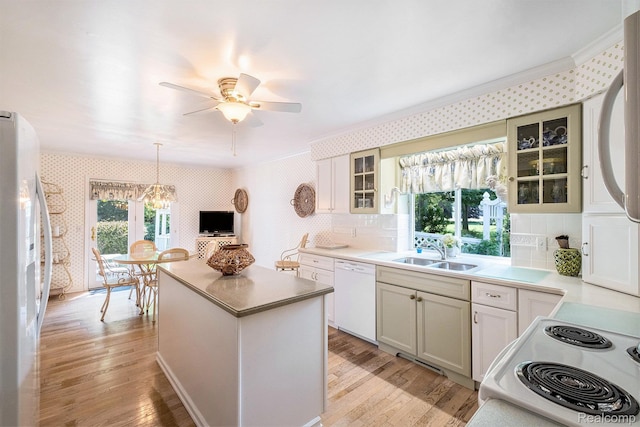 2032 Crestline, Burton, MI 48509 - kitchen with white appliances, wallpapered walls, ornamental molding, light wood-style flooring, and a center island
