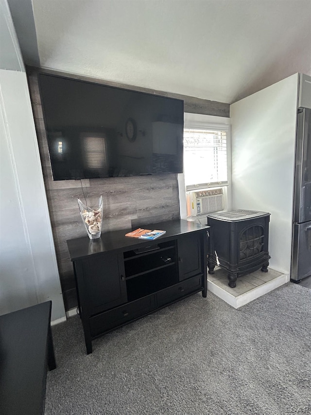 2907 W Ferndale Dr, Manitou Beach, MI 49253 - living area with a wood stove, vaulted ceiling, and cooling unit