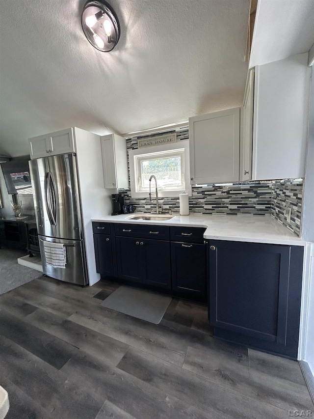 2907 W Ferndale Dr, Manitou Beach, MI 49253 - kitchen with freestanding refrigerator, backsplash, light countertops, dark wood-style floors, and a textured ceiling