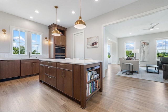 273 Waters Edge Dr, Saint Joseph, MI 49085 - kitchen with light wood-style floors, light countertops, open floor plan, recessed lighting, and a kitchen island