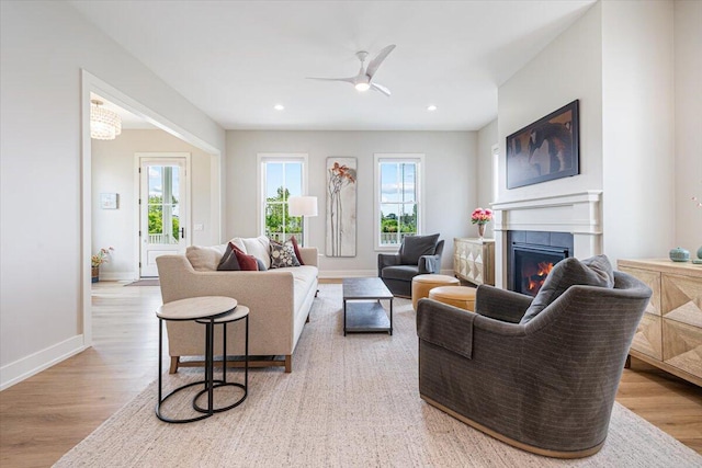 273 Waters Edge Dr, Saint Joseph, MI 49085 - living area with a warm lit fireplace, light wood finished floors, ceiling fan, and recessed lighting