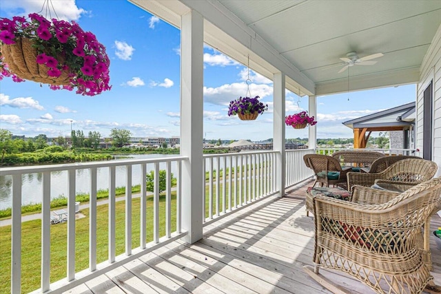 273 Waters Edge Dr, Saint Joseph, MI 49085 - wooden deck with a water view, a ceiling fan, and a yard