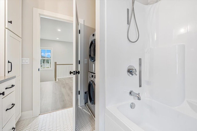 273 Waters Edge Dr, Saint Joseph, MI 49085 - bathroom featuring stacked washer / dryer, tub / shower combination, recessed lighting, and tile patterned floors
