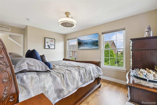 750 2nd St Unit 27, Wyandotte, MI 48192 - bedroom with multiple windows and wood finished floors