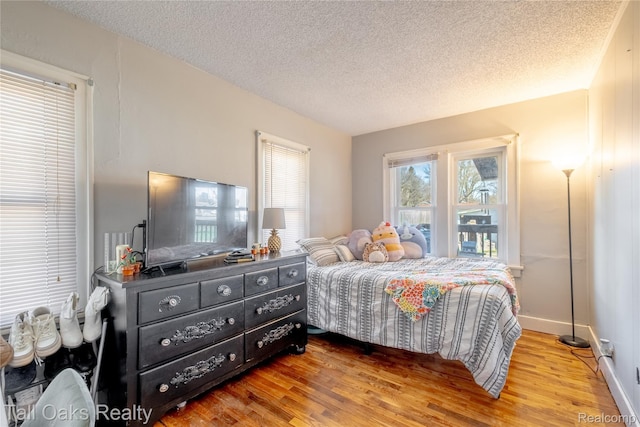 6123 Lapeer Rd, Burton, MI 48509 - bedroom featuring wood finished floors and a textured ceiling