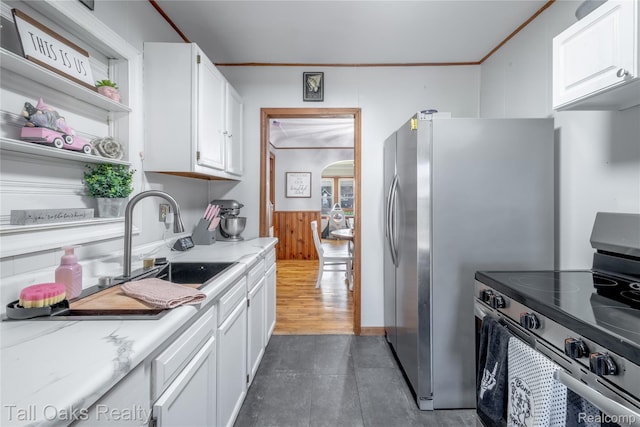 6123 Lapeer Rd, Burton, MI 48509 - kitchen featuring stainless steel appliances, ornamental molding, white cabinetry, arched walkways, and open shelves
