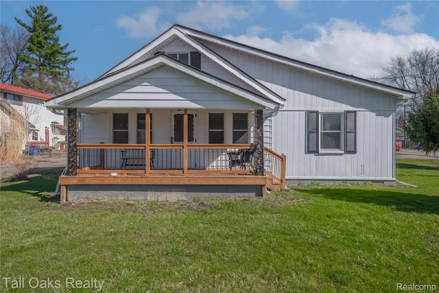6123 Lapeer Rd, Burton, MI 48509 - rear view of house featuring a porch and a yard