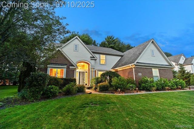 4583 Racewood Dr, Commerce Twp, MI 48382 - traditional-style house with brick siding and a front lawn