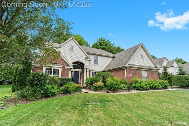 4583 Racewood Dr, Commerce Twp, MI 48382 - traditional-style house with brick siding and a front lawn