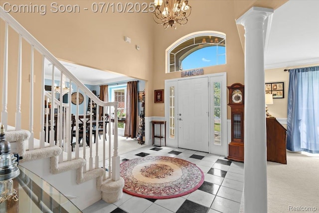 4583 Racewood Dr, Commerce Twp, MI 48382 - foyer with stairway, decorative columns, a chandelier, crown molding, and a towering ceiling