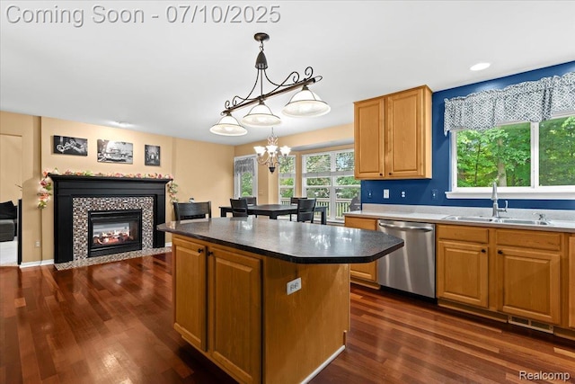 4583 Racewood Dr, Commerce Twp, MI 48382 - kitchen featuring dishwasher, dark wood-style flooring, a chandelier, a fireplace, and a center island