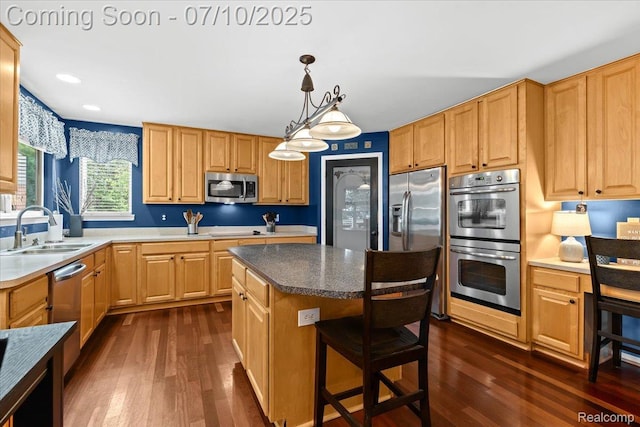 4583 Racewood Dr, Commerce Twp, MI 48382 - kitchen with appliances with stainless steel finishes, dark wood-type flooring, a kitchen bar, a center island, and recessed lighting