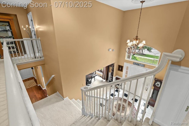 4583 Racewood Dr, Commerce Twp, MI 48382 - stairway featuring a chandelier and wood finished floors