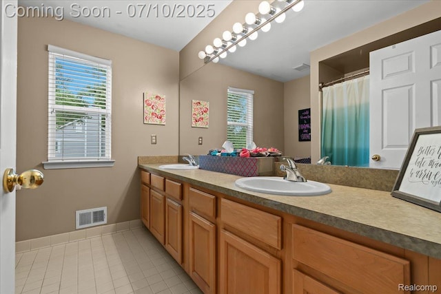 4583 Racewood Dr, Commerce Twp, MI 48382 - full bath with double vanity, healthy amount of natural light, and tile patterned floors