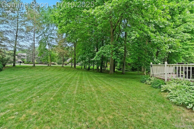 4583 Racewood Dr, Commerce Twp, MI 48382 - view of grassy yard featuring a wooden deck