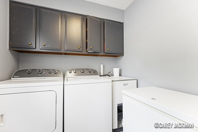 3910 Walker Ave NW, Grand Rapids, MI 49544 - washroom featuring washer and clothes dryer and cabinet space