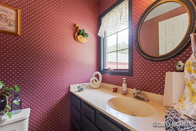3910 Walker Ave NW, Grand Rapids, MI 49544 - half bathroom with wallpapered walls and vanity