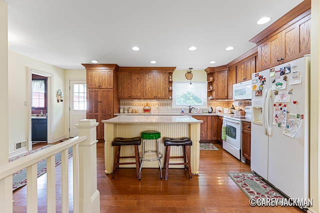 3910 Walker Ave NW, Grand Rapids, MI 49544 - kitchen with white appliances, open shelves, dark wood-type flooring, a kitchen island, and decorative backsplash