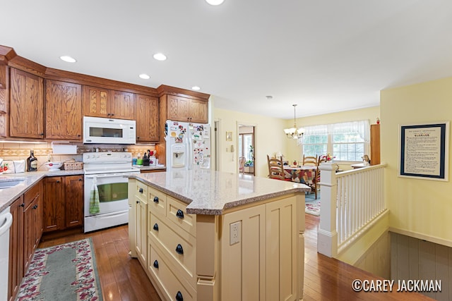 3910 Walker Ave NW, Grand Rapids, MI 49544 - kitchen with white appliances, dark wood-style flooring, light stone counters, decorative backsplash, and a chandelier