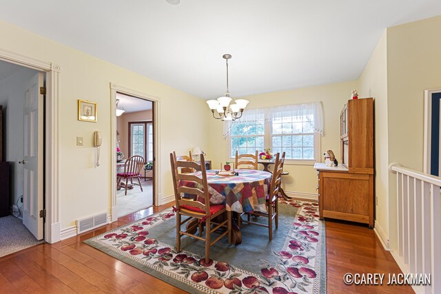 3910 Walker Ave NW, Grand Rapids, MI 49544 - dining area with plenty of natural light, hardwood / wood-style flooring, and a chandelier