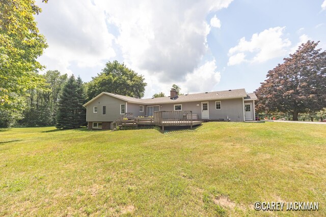 3910 Walker Ave NW, Grand Rapids, MI 49544 - rear view of property with a deck, a lawn, and a chimney