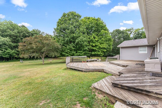 3910 Walker Ave NW, Grand Rapids, MI 49544 - view of green lawn with a wooden deck and view of scattered trees